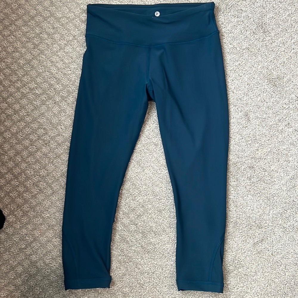 Teal capri length leggings with criss cross detail